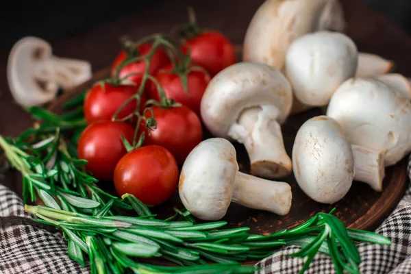 Fresh cherry tomatoes, sprigs of rosemary and champignon mushroo — Stock Image Fresh cherry tomatoes, sprigs of rosemary and champignon mushroo Stock Picture