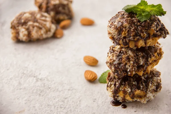 Useful homemade almond cake with coconut chips on a light backgr