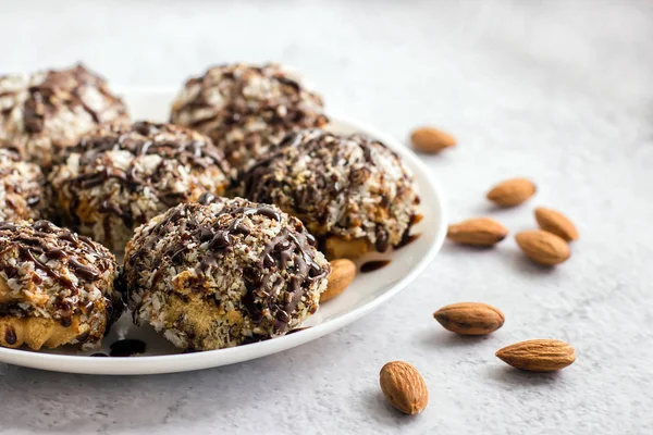 Useful homemade almond cake with coconut chips on a light backgr