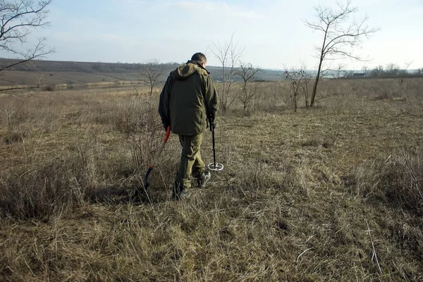 man with a metal detector in search of historical values