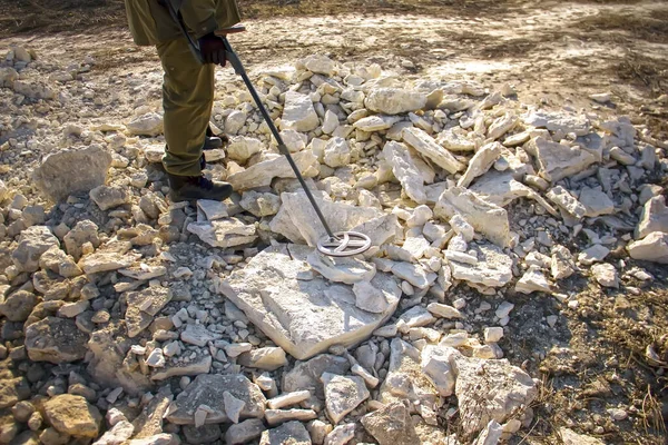 A man with a metal detector in search of historical values