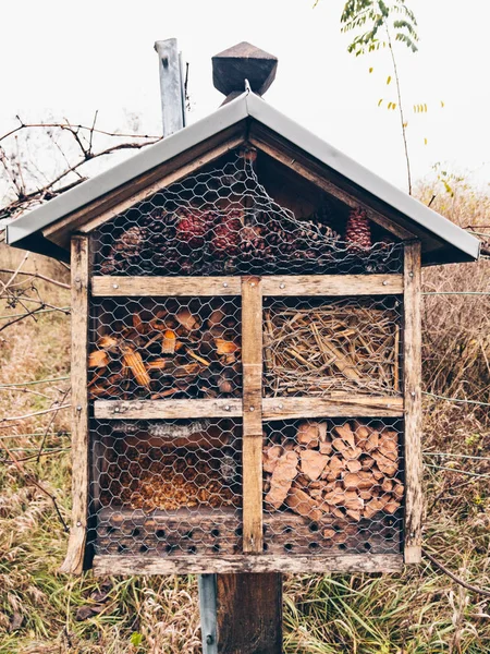 A natural brown coloured insect hotel for bees and other animals during autumn time.