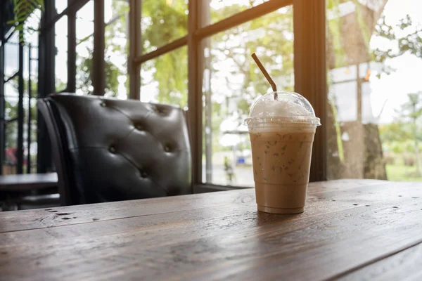 Iced cappuccino on wooden table beside in coffee shop, lifestyle and relax