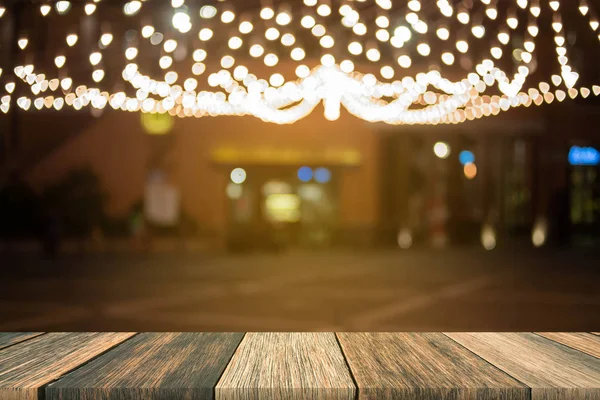 Wazig houten tafel in de voorkant wazig nacht straatmarkt met b — Stockfoto