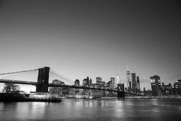 New York, United States of America - November 18, 2016: Skyline of Lower Manhattan with Brooklyn Bridge at sunset.