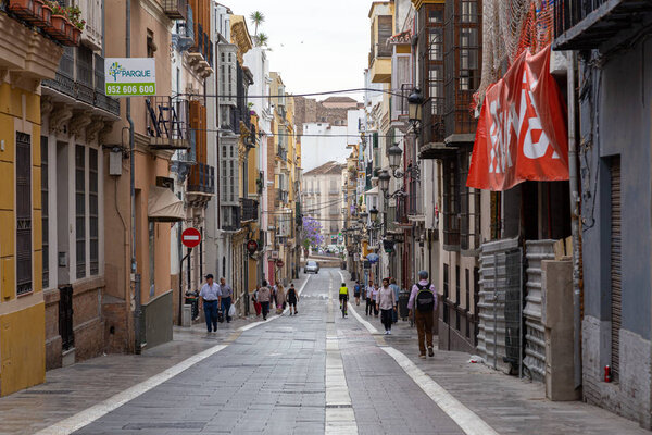 Malaga, Spain - May 24, 2019: People in the charming streets in the historic city centre.