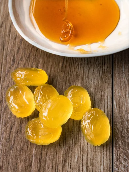 Honey candies on wood background