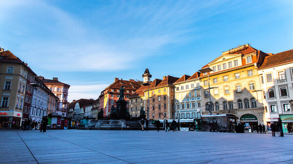 Graz, Styria / Austria - 20.01.2019: Statue fountain in front of the town hall in Graz, Austria Painted facades and the Clock Tower in the old town of Graz, Austria Travel destination.