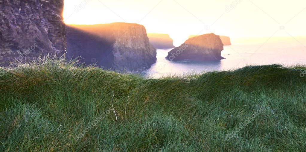 Cliffs of Kilkee in Ireland county Clare during sunset. Tourist 