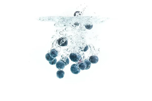 Blueberries falling into water. — Stock Photo, Image