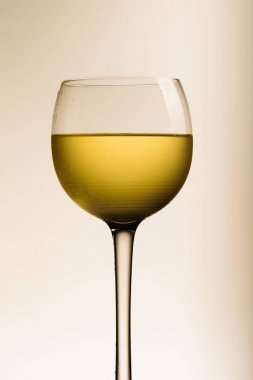 Beyaz arka planda bir bardak beyaz şarap.