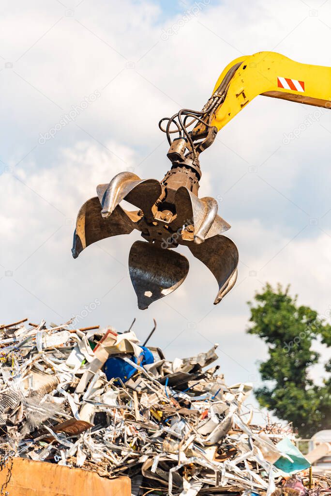 Close-up of a crane for recycling metallic waste on scrapyard