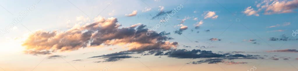 Panorama, sunset over fields and Austrian village with dramatic sky and colorful clouds