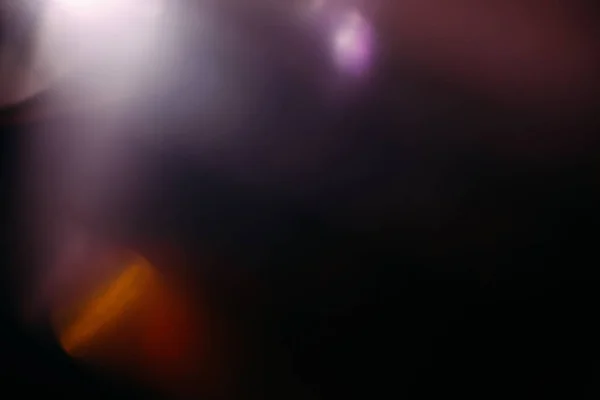 Lente flare colorido abstrato luz brilho preto — Fotografia de Stock