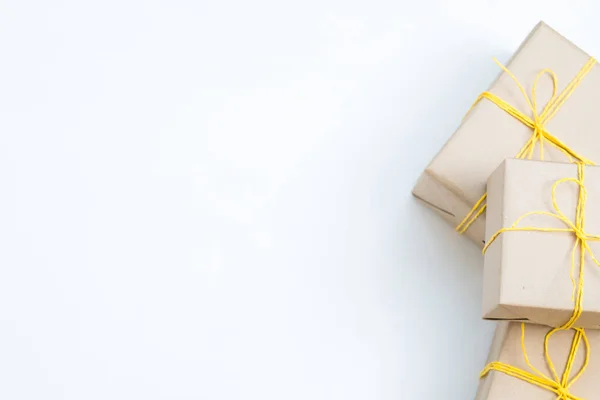 Рождественские Подарки Подарочных Коробках Завернутых Бумагу Завязанных Желтой Бечевкой Три — стоковое фото