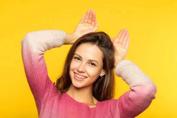 Funny playful girl fooling around faking ears palm — Stock Photo, Image