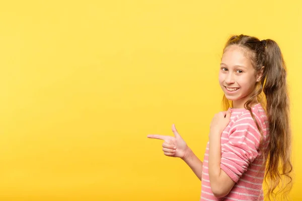 Look left smiling girl point finger advertising — Stock Photo, Image