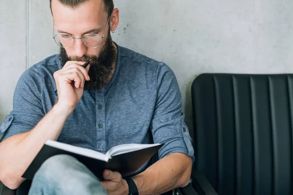 focused man reading notepad business data analysis