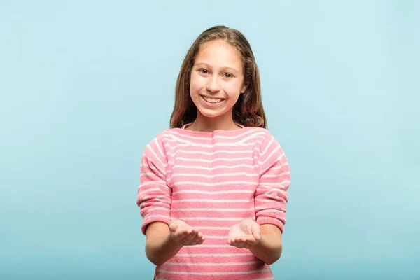 Sorrindo menina segurando objeto virtual mãos vazias — Fotografia de Stock
