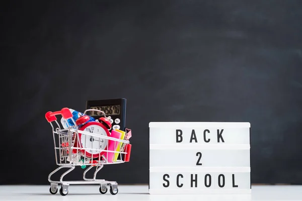 School supplies shopping education lightbox cart — Stock Photo, Image