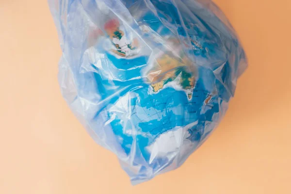 Aarde vervuiling globe strakke plastic zak — Stockfoto