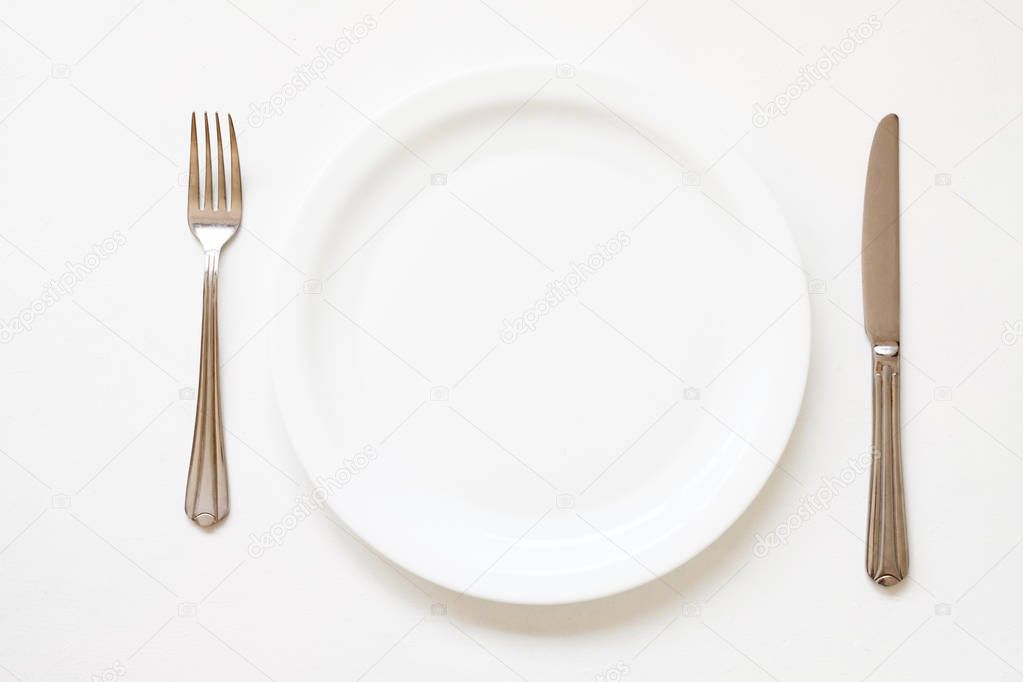 dinner setting empty porcelain plate cutlery