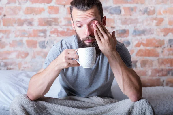 Monday morning drowsiness man bed cup distracted — Stock Photo, Image