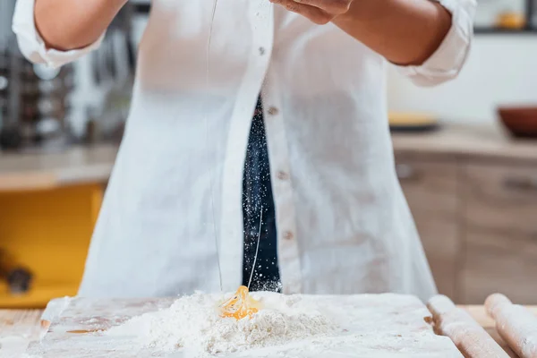 Woman making dough cracking egg flour baking — Stock Photo, Image