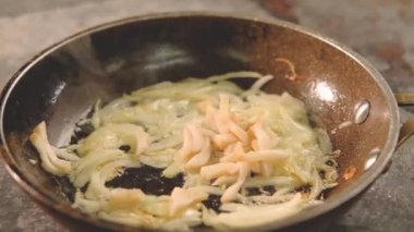 yemek aşçı yemek şef dilimlenmiş kalamar soğan tava ekleyin