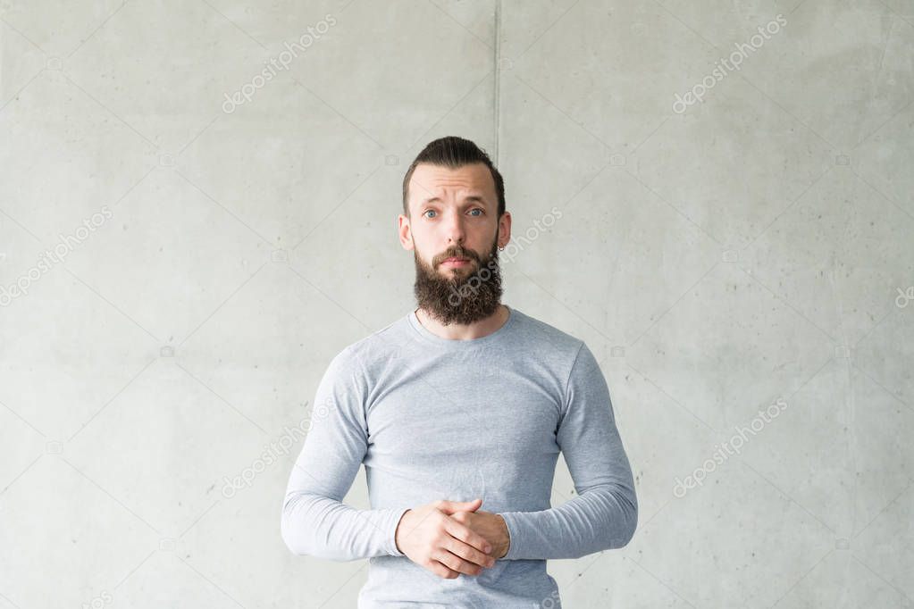 empathy compassion bearded hipster guy gray wall