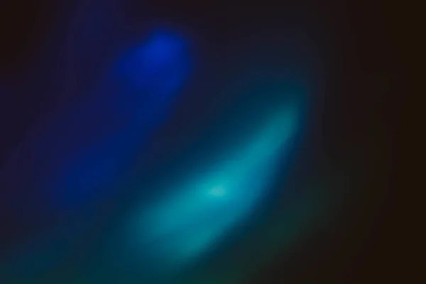 Blue glow dark background lens flare light leak — Stock Photo, Image