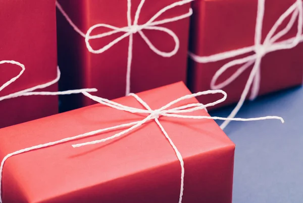 Gift delivery service red paper boxes white cord — Stock Photo, Image