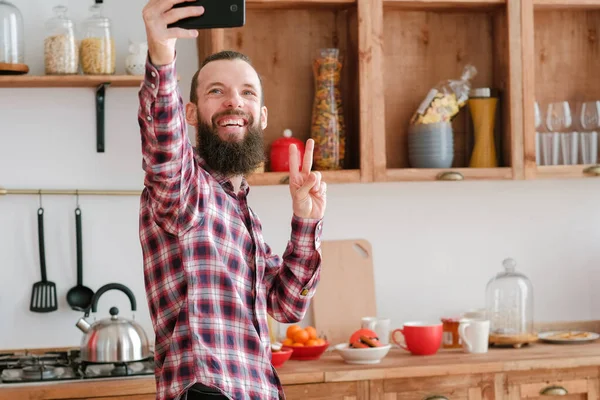social media addiction bearded guy selfie kitchen