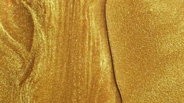 Glitter vätska rörelse smält guld flytande färg flöde — Stockvideo