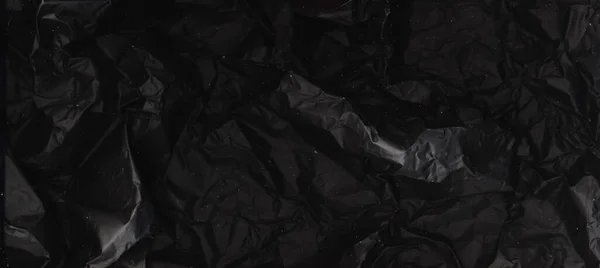 Czarny folia tło zgnieciony tekstura spalony papier — Zdjęcie stockowe