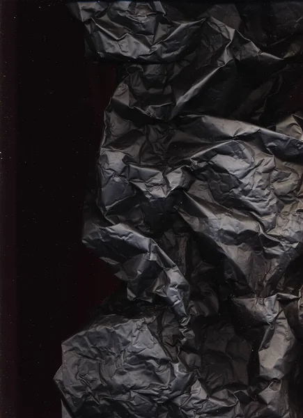 black wrinkled paper burnt coal texture crumpled