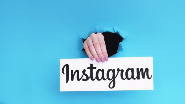 Instagram logo social media hand breakthrough hole — Stock Video
