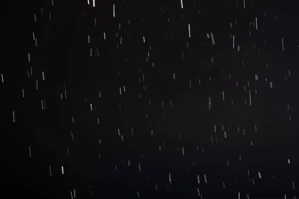 Schneefall Hintergrund verschwimmen fliegen weißen Staub schwarz — Stockfoto