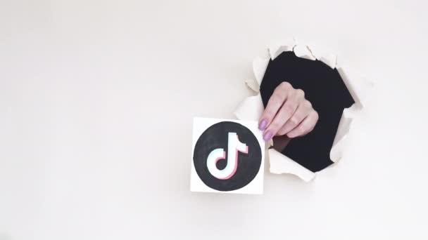 Tiktok logo social media hand breakthrough paper — Stock Video