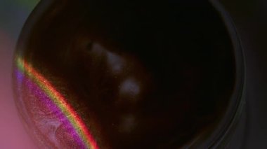 Boya küresi. Parlak. Sızdıran soyut neon akrilik yaratıcı arkaplan üzerine odaklanmış mor yeşil yuvarlak gökkuşağı emülsiyonu.