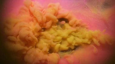 Boya sıçraması. Bulut buharı. Odaklanamayan pembe renkli mürekkep kıvrımlı sıvı soyut canlı sanat arka planında yüzüyor..