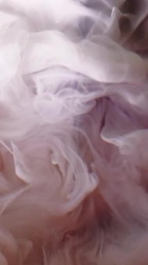 Dikey video. Duman boyası. Renk dumanı. Beyaz sıvı boya turuncu renkli kıvrımlar bulanık su sanatı soyut arka plan.