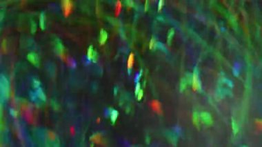 Neşeli bir parıltı. Bulanık sızıntı rengi. Yeşil turuncu mavi yanıp sönen mercek modern Bokeh Işığı 'nın soyut arka planında yanıp sönüyor.