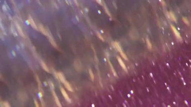 Işın titreşimi. Odaklanamayan renkli işaret fişeği. Açık yeşil, mor mavi soyut arkaplan üzerinde bulanık beyaz parçacıklar.