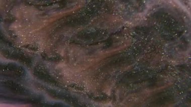 Parıldayan ışık. Sıçrama sıvısı. Soyut sanat arkaplanındaki pembemsi mavi boya kimyasal pigment parçacıkları.