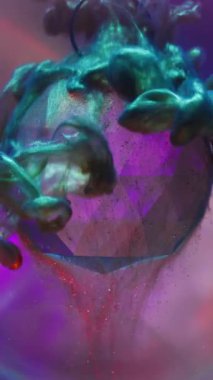 Dikey video. Parıltı yayılıyor. Sis mürekkebi. Parlak sanat dumanı cam elması kaplıyor. Polonyalı çok renkli karışım neon sıvısı çözünmüş yuvarlak mercek arka planı.