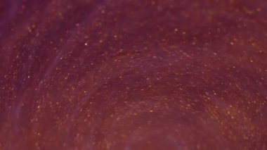 Mürekkep fırıldağı. Akrilik girdap dokusu. Odaklanmamış sarı mor renk simleri soyut yaratıcı sanat arka planında akıyor..