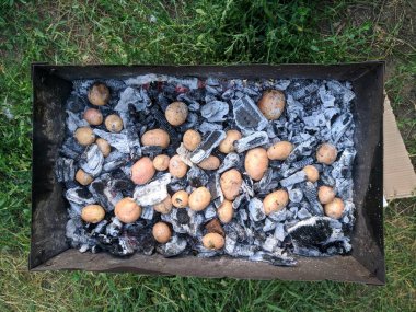 Bir kamp yangınında sıcak kömürlerde Fırında Patates. Üstte görüntü