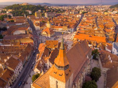 Arka tarafta siyah katedral ve dağ ile Brasov şehir manzarası 