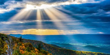 Sunrays bursting through storm clouds in Shenandoah National Park, Virginia clipart
